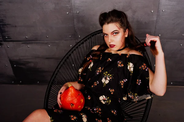 Black girl in dress with bright make-up and pumpkin sitting on c — Stock Photo, Image