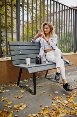 Beyaz fincan kahve ile şık kıvırcık sarışın model kız aşınma