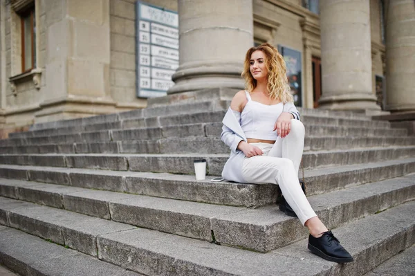 Stylish curly blonde model girl wear on white with cup of coffee — Stock Photo, Image