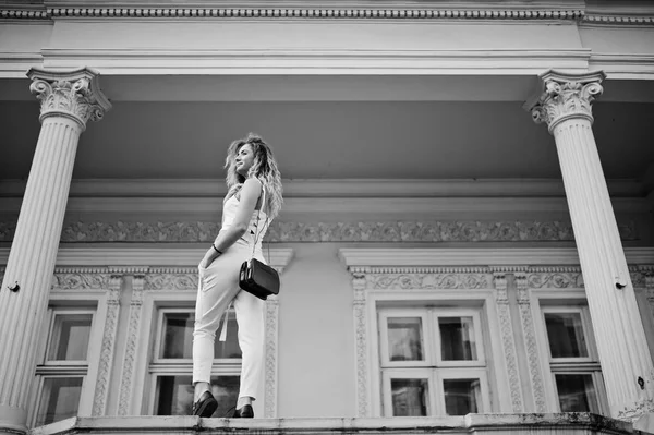 Stylish curly blonde model girl wear on white posing against old — Stock Photo, Image