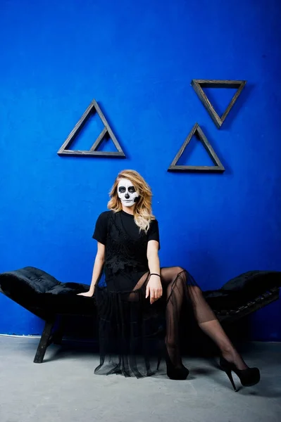 Halloween lebka tvoří oblečení dívka v černém modré zdi na — Stock fotografie