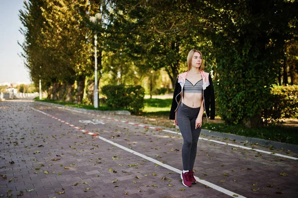 Young girl has the training and doing exercise outdoors. Sport,