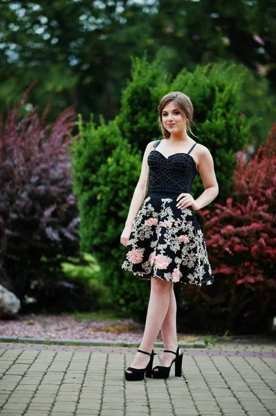 Retrato de uma linda jovem no vestido floral preto andando — Fotografia de Stock