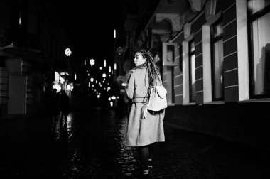 Gece şehir Caddesi'nde yürürken dreadlocks ile kız.