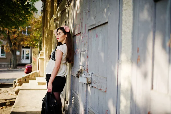 Stylish brunette girl wear on leather jacket and shorts posing a — Stock Photo, Image