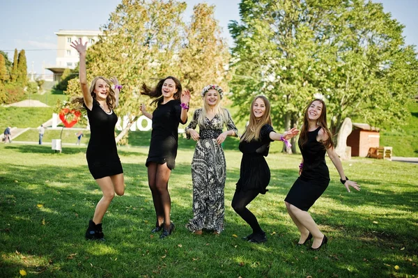 Fünf Mädchen tragen bei Junggesellenabschied schwarze Springerstiefel. — Stockfoto