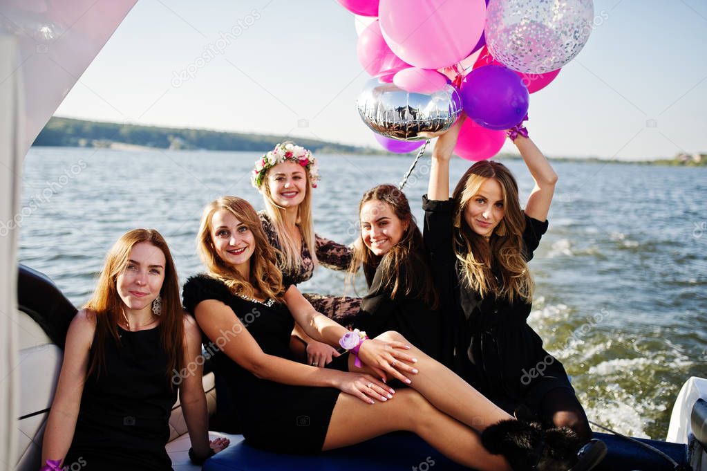 Girls having fun at yacht on hen party.