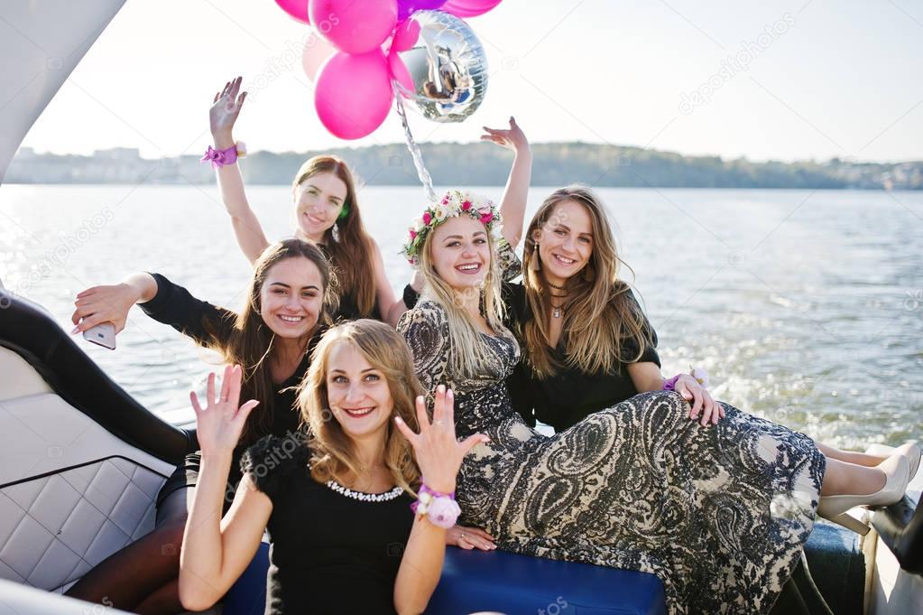 Girls having fun at yacht on hen party.