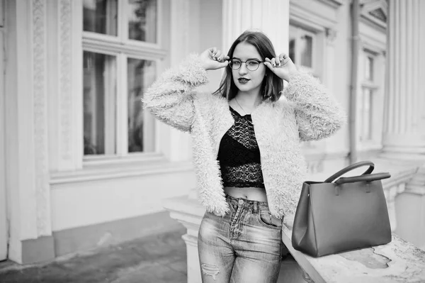 Fille aux cheveux rouges dans des lunettes avec sac à main rouge posé près de vintage h — Photo