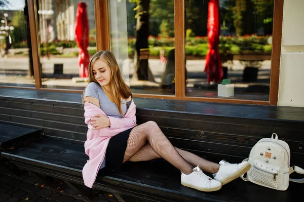 Young blonde girl in black skirt and pink coat with woman backpa — Stock Photo, Image