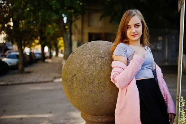 Young blonde girl in black skirt and pink coat posed at sunny da — Stock Photo, Image