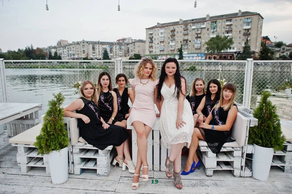 Group of 8 girls wear on black and 2 brides at hen party having — Stock Photo, Image