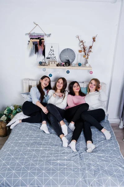 Four cute friends girls wear on warm sweaters and black pants on — Stock Photo, Image