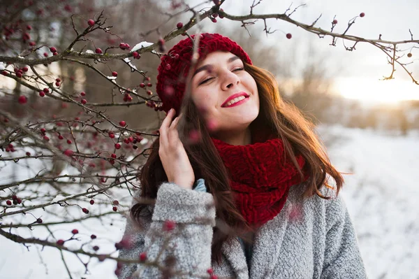 Porträt eines sanften Mädchens in grauem Mantel, roter Mütze und Schal in der Nähe — Stockfoto