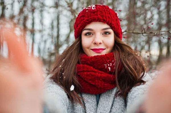 Portrait of gentle girl in gray coat , red hat and scarf near th — Stock Photo, Image