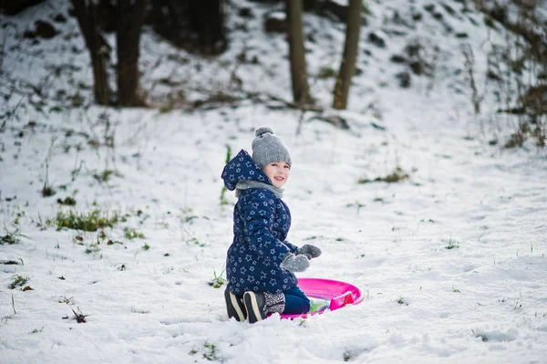 Cute little girl with saucer sleds outdoors on winter day. — Stock Photo, Image