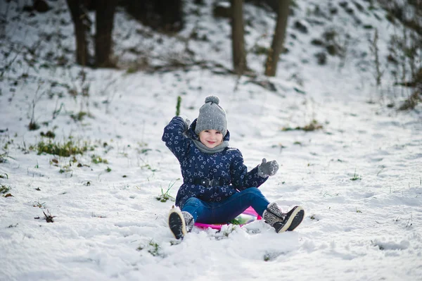 Cute little girl with saucer sleds outdoors on winter day. — Stock Photo, Image