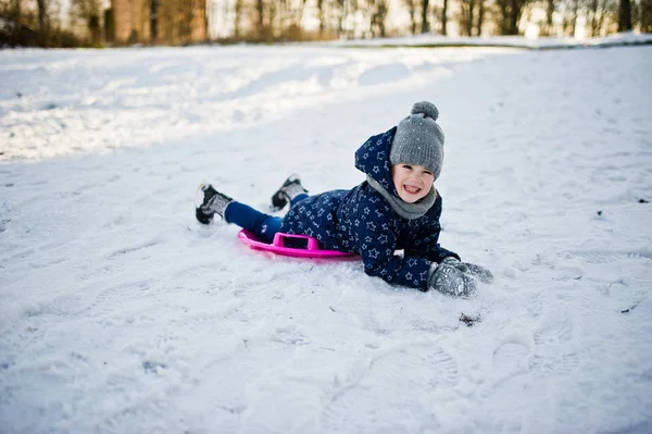 Cute little girl with saucer sleds outdoors on winter day. — Stock Photo, Image