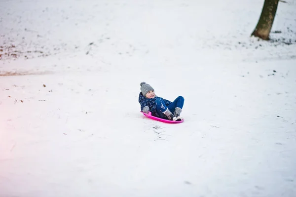 Cute little girl with saucer sleds outdoors on winter day. — Stock Photo, Image