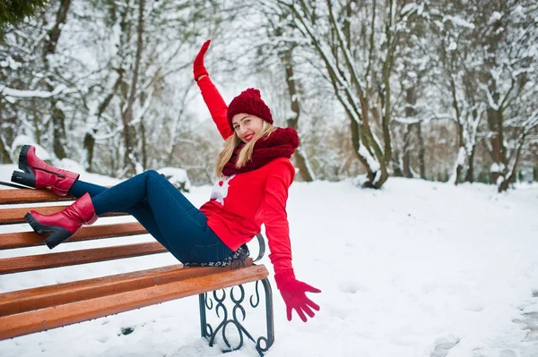 Chica rubia en bufanda roja, sombrero y suéter de santas posando en el parque — Foto de Stock