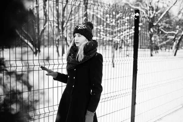 Blond meisje in de rode sjaal en jas lopen in het park op de winterdag. — Stockfoto