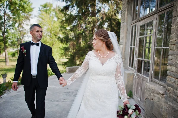 Wedding couple walking around the castle on their wedding day. — Stock Photo, Image