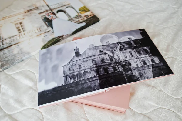 Pages with wedding photos of a photobook or photo album on bed. — Stock Photo, Image