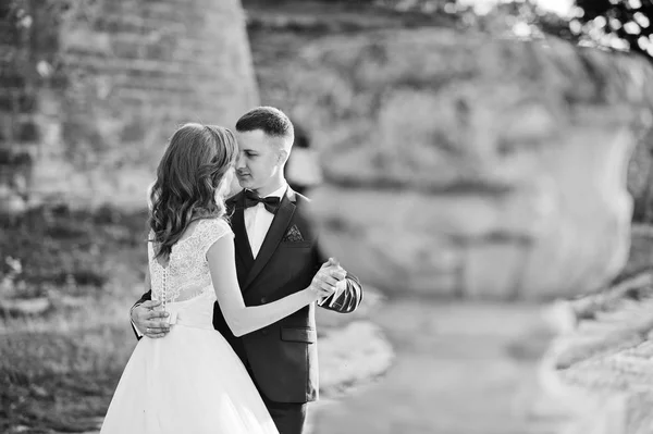 Fabulous wedding couple walking around the castle territory on t — Stock Photo, Image