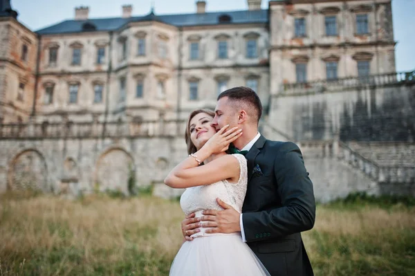 Fabuleux couple de mariage posant devant un vieux château médiéval — Photo