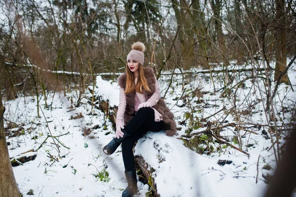 Stylová holka v kožichu a čepice v zimním lese. — Stock fotografie