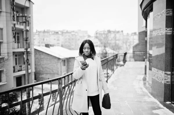 African american tjej i röd hatt och rosa päls på gatan av staden — Stockfoto