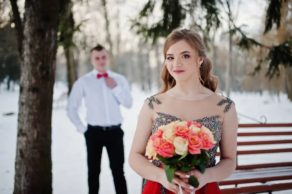 Amazing couple in winter fairytale forest in love. Girl in red b — Stock Photo, Image