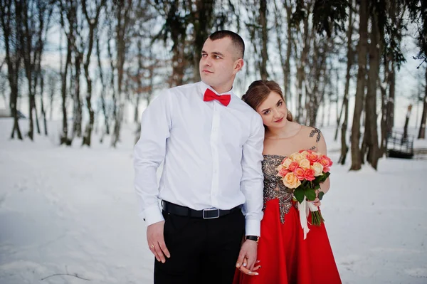 Amazing couple in winter fairytale forest in love. Girl in red b — Stock Photo, Image