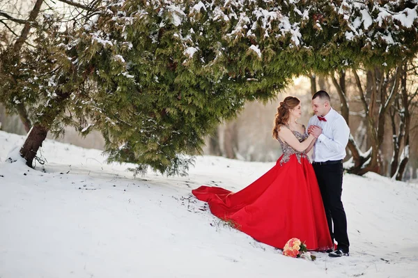 Amazing couple in winter fairytale forest in love. Girl in red b — Stock Photo, Image