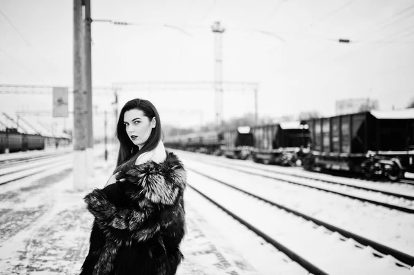 Brünettes Mädchen in grünem Pelzmantel auf dem Bahnhofsvorplatz in Winte — Stockfoto