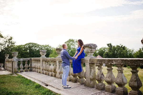 Lovely couple in love against old castle. Girl in blue dress. — Stock Photo, Image