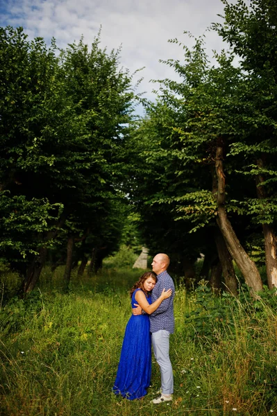 Lovely couple in love at green park. Girl in blue dress. — Stock Photo, Image