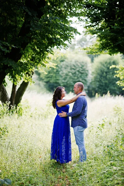 Lovely couple in love at green park. Girl in blue dress. — Stock Photo, Image