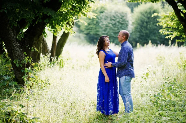 Lovely couple in love at green park. Girl in blue dress. — Stock Photo, Image