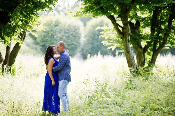 Lovely couple in love at green park. Girl in blue dress. — Stock Photo, Image