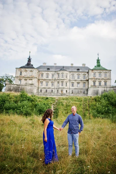 Lovely couple in love against old castle. Girl in blue dress. — Stock Photo, Image