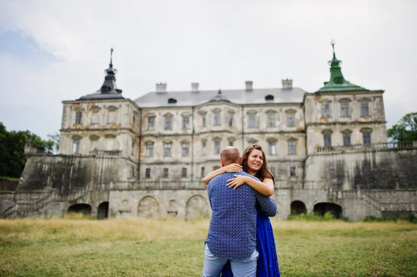 Encantador casal apaixonado contra o velho castelo. Menina em vestido azul . — Fotografia de Stock