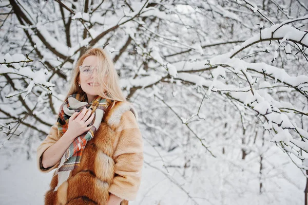 Portraiy blondýnka v brýlích, červené kožich a šátek na wi — Stock fotografie