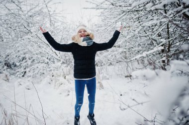Sarışın kız kar kış gününde eğleniyor.