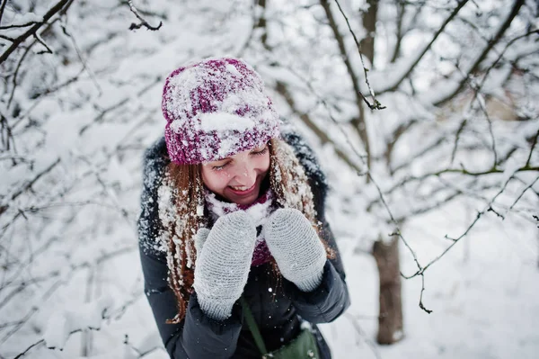 Portret dziewczynki w zimowy śnieżny dzień w pobliżu śniegu objętych drzewa. — Zdjęcie stockowe