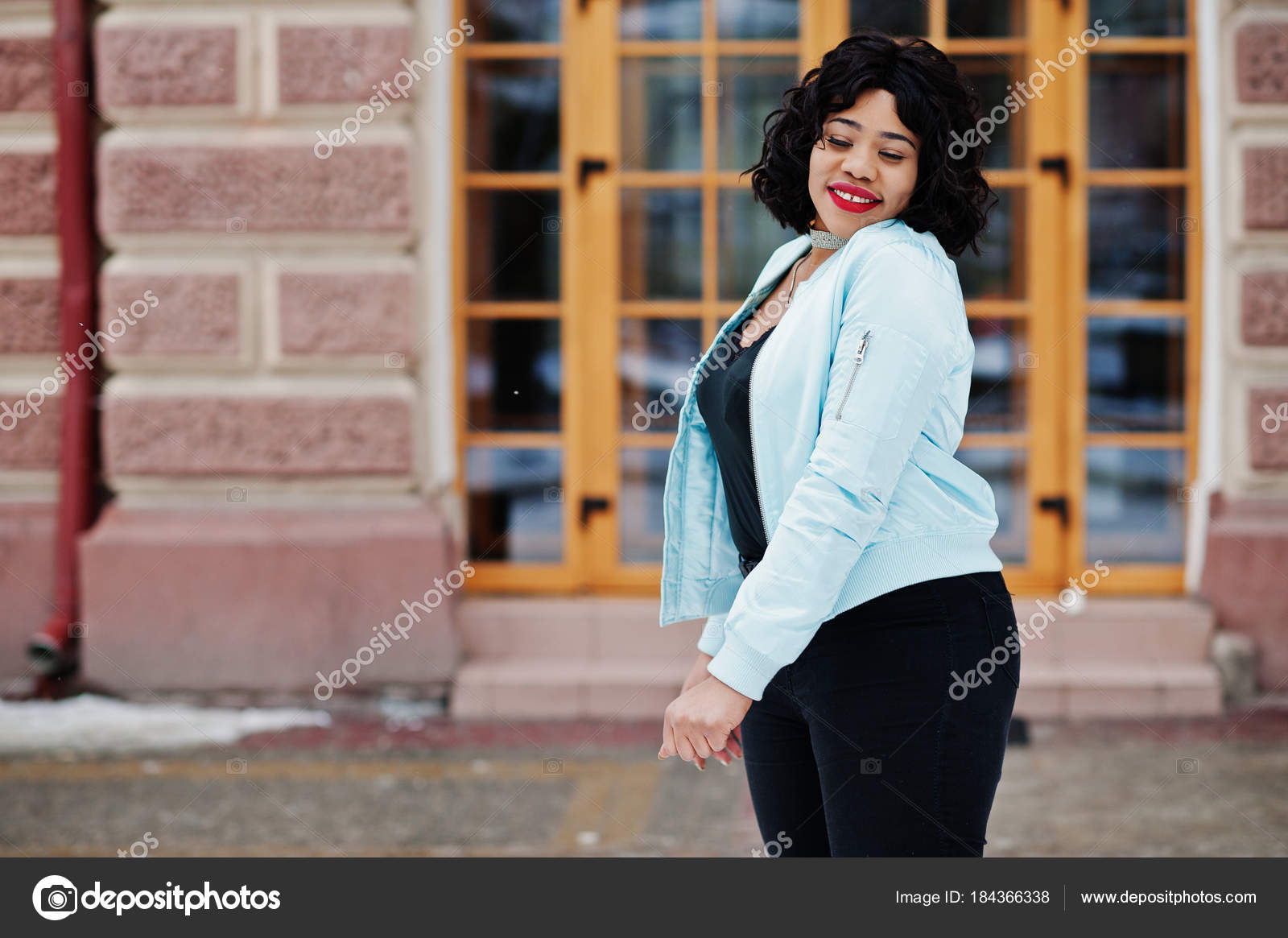 Stylish african american plus size model at streets of city on w