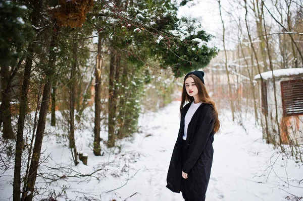 Fashionable long legs brunette model in long black cloak and hat — Stock Photo, Image
