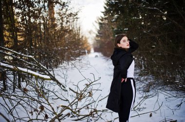 Şık uzun bacaklı esmer uzun siyah pelerin yarattığı o modelde