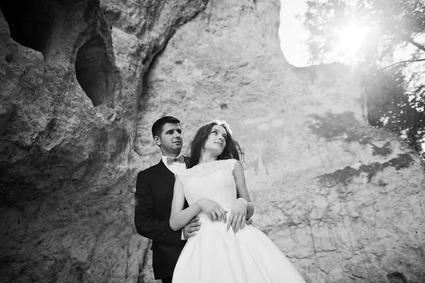 Pareja de boda contra cueva en el día de verano . — Foto de Stock