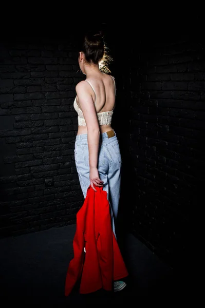 Elegante chica morena en el sujetador contra la pared de ladrillo negro estudio . —  Fotos de Stock